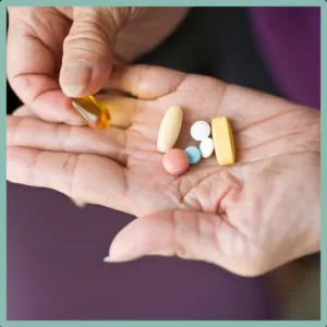 A palm holding several types of medication. 