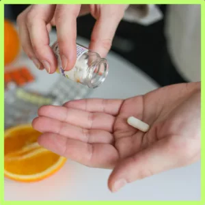 A person puts a mineral supplement into his hand. 