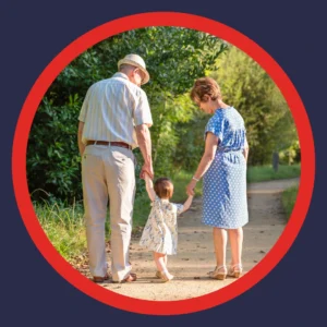 Two grandparents walk with their toddler granddaughter. 