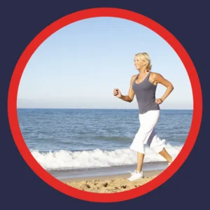 An older woman jogs on the beach.