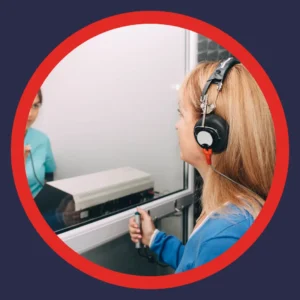 A woman takes a hearing test. 