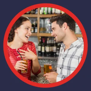 Two people discuss things over a drink. 