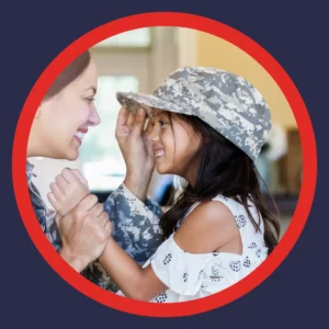 A mom puts her soldier's hat on her daughter. 
