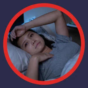 A woman lies wide awake in bed. 