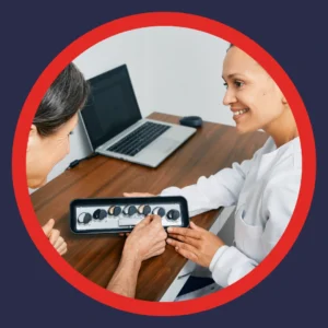 A woman looks at hearing aids with her audiologist. 