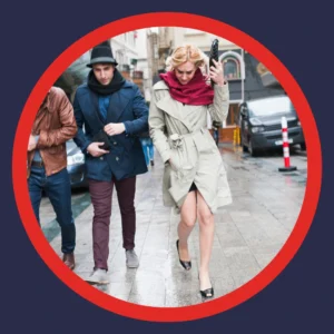People walk in windy conditions. 