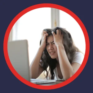 A woman looks frustrated at her laptop. 