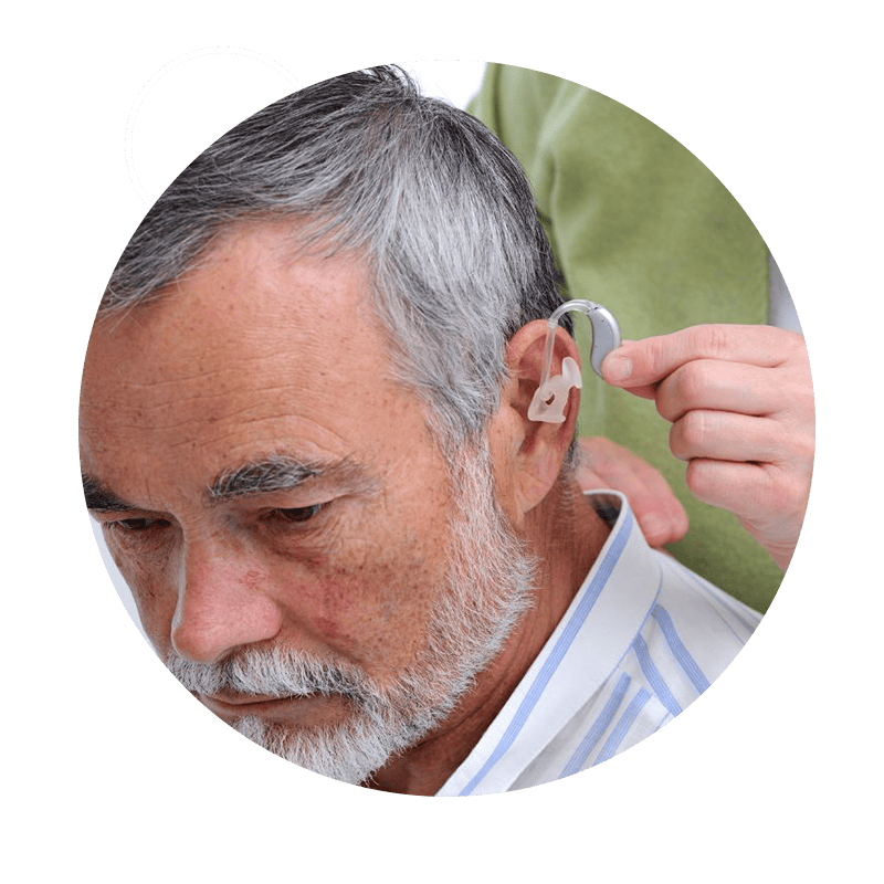 A hearing provider fits a hearing aid. 