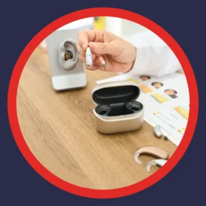 An audiologist demonstrates a hearing aid.