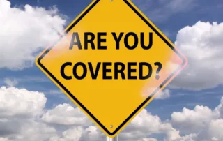 A yellow traffic sign asks, “Are You Covered?”