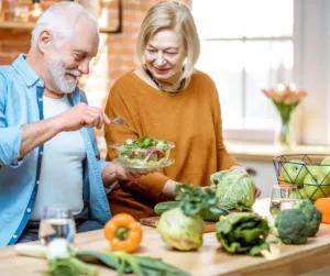 An older couple makes a salad