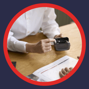 An audiologist shows a rechargeable hearing aid. 