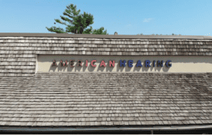 The roof of an office building says “American Hearing.” 