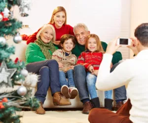 Grandparents, daughter, and grandchildren pose for a holiday photo. 