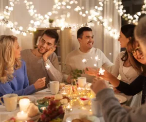 People chat as they sit around a festively decorated table.