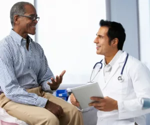 A man consults with his doctor at a visit. 