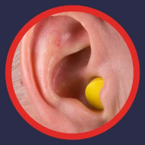 An ear has an ear plug in it. 