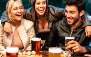 Friends enjoy a night out with beer and snacks.