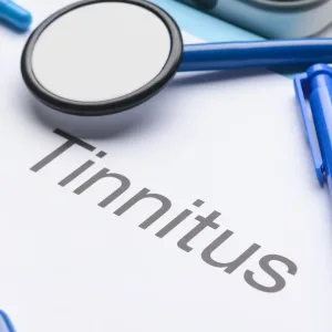 The word “tinnitus” is on a white background. 