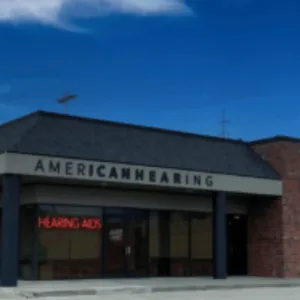 A storefront says “American Hearing” below a blue sky. 