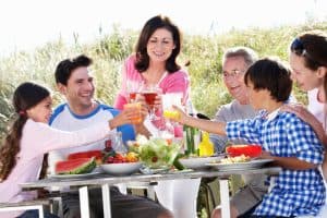 A family eating outside. 