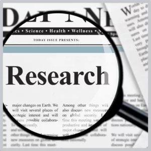 A magnifying glass highlights the word "research" in a paper. 