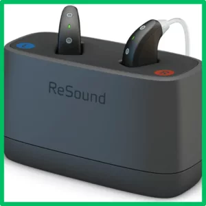 ReSound Omnia hearing aids sit in their charging case. 