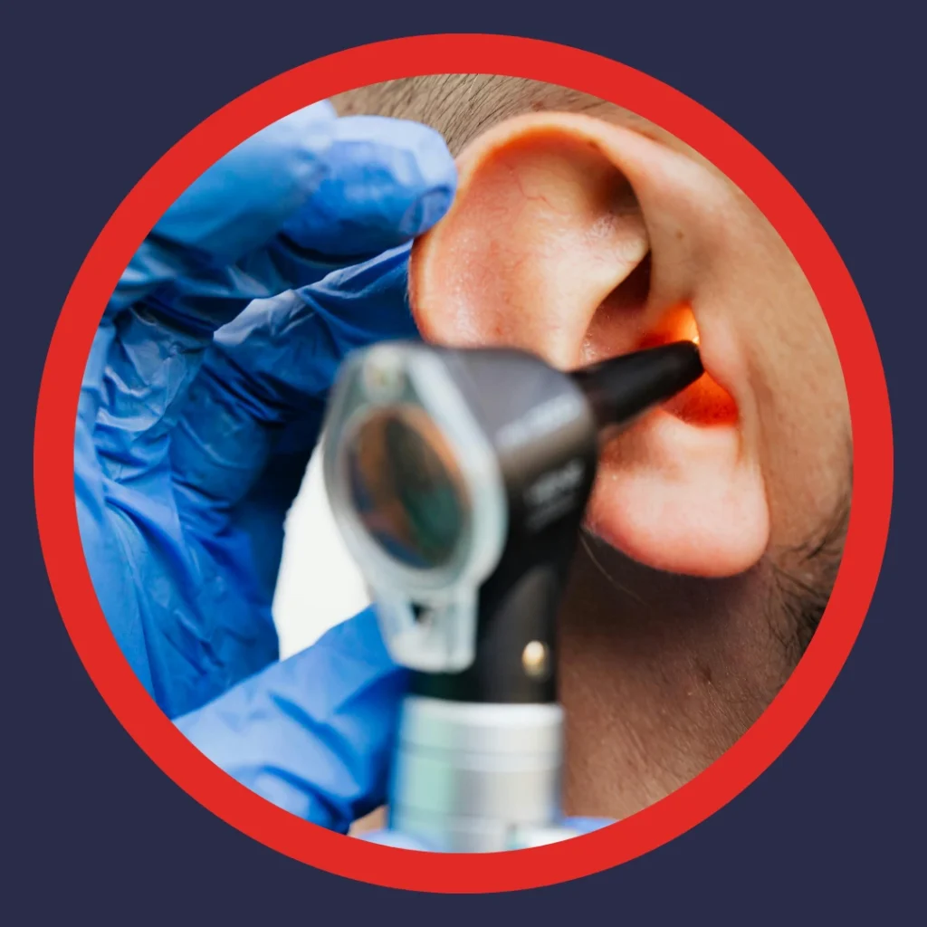 An audiologist looks in an ear.