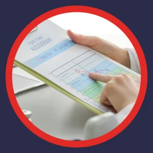 An audiologist points at an audiogram.