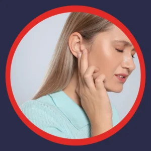 A woman holds her ear unhappily. 