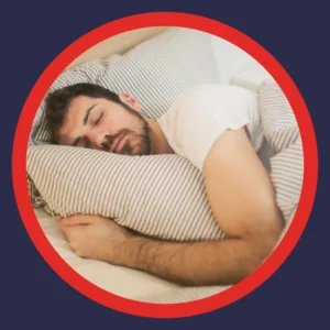 A man sleeps deeply in a bed. 