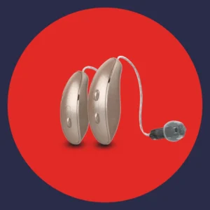 A pair of Starkey Edge AI hearing aids sit on a red background. 