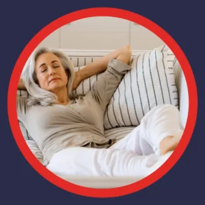 A woman rests comfortably on her couch. 