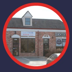 An American Hearing storefront sits in the sunlight. 
