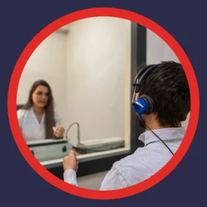 An audiologist gives a man a hearing test. 