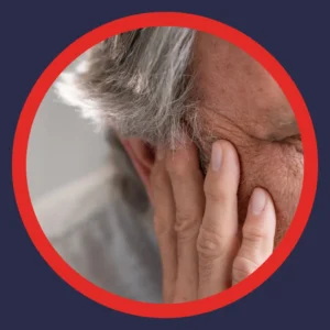 An older man holds his ear. 