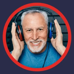 A man smiles while taking a hearing test. 