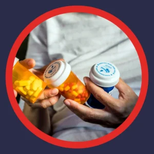 Hands hold three bottles of prescription medications.