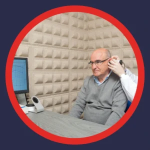 An older man has his ears examined by an audiologist. 