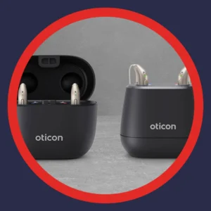 Oticon Intent hearing aids sit in their charging case. 