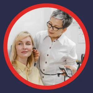An audiologist checks a woman's ear. 