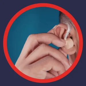 Someone puts a hearing aid into their ear.